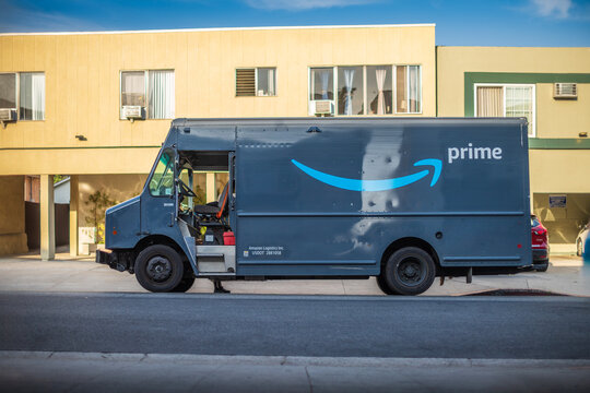 LOS ANGELES, CA - June 13, 2025: Amazon Prime delivery truck parked next to a yellow building on a residential street in city of West Hollywood, California
