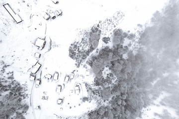 The village, the Alpine pasture and the frozen forest, Alps landscape, Valtellina, Italy