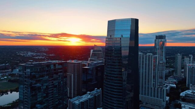 Modern glass high-rises of Austin downtown, Texas, USA. Fantastic sunset over the green cityscape of the city at sunset.