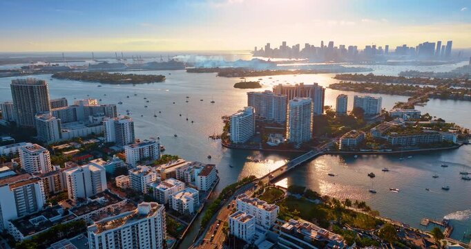 Approaching Biscayne Bay with numerous boats on. High-rise skyline of Miami, Florida, USA at backdrop. Aerial view.
