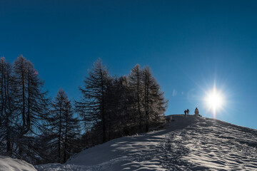 Silhouette of two men on mountain ridge, Alps mountains