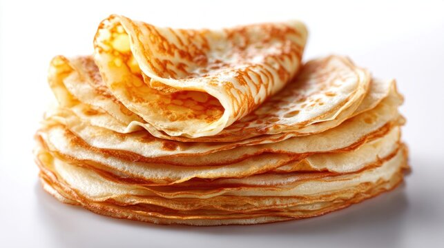Stack of golden pancakes on a white surface, ready to be served
