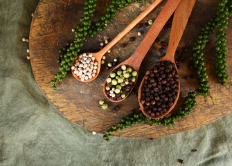 white, black and green peppercorns spices