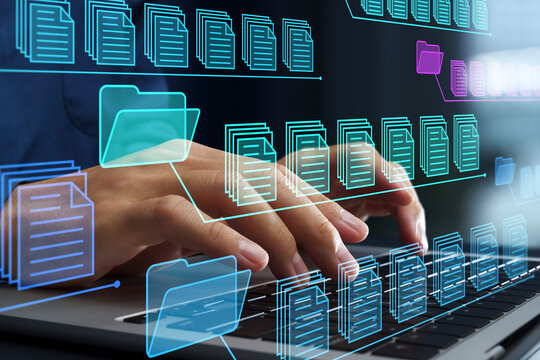 Business document management system. File and folder icons. Legal document archiving and retrieval solutions. Businessman using laptop computer to control document versions.