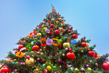 Colorful Christmas tree ornaments and ribbons in Warsaw Poland during winter holiday under blue sky