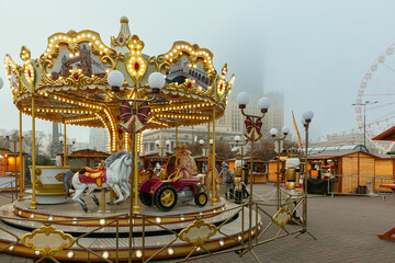 Decorated Christmas carousel and market stalls in central Warsaw Poland during winter holiday season