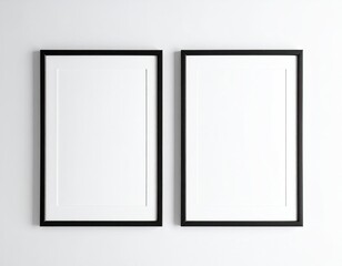 Two black frames, white matte, mounted on a white wall