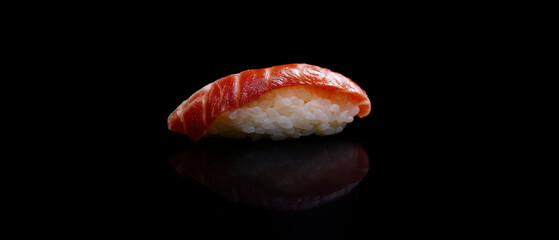 Nigiri sushi with red fish on black background, banner. 