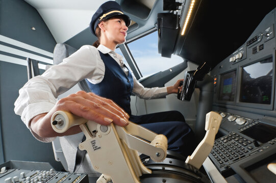 Flight captain operating an airplane cockpit in uniform