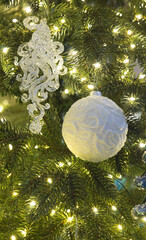 Christmas toys and luminous garlands on the tree