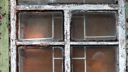 glass Window with old wooden frame. abandoned building. old window. finely broken glass. old house, retro. cracked window frame. cracked old paint, pieces of glass. white wall, space for text