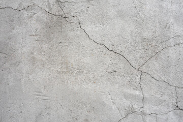 Obraz premium clay wall. the old clay wall is crumbling. surface wall for vintage background. Wall texture for background. old cracked plaster, grey cement floor, needs repair, restoration