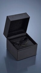 Open black box with dark fabric tied with a bow