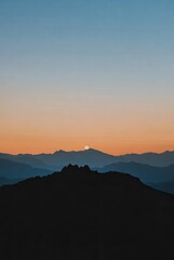 Fototapeta premium Majestic mountain landscape at sunrise or sunset with a vibrant gradient sky and layered