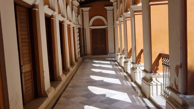 Picturesque interior of a colonial-era mansion in Sonargaon, Bangladesh. Sunlit columns and ornate architecture highlight historic design and preserved cultural heritage in the museum
