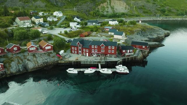 &Aring;, is a historic fishing village at the southern tip of the Lofoten Islands, Norway. Traditional red rorbuer cabins line the rocky coastline, surrounded by dramatic mountains.