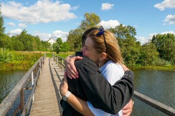 A smiling couple in love, enjoying each other's company in the great outdoors on a sunny summer day.