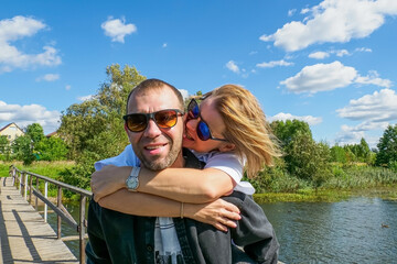 A smiling couple in love, enjoying each other's company in the great outdoors on a sunny summer day.