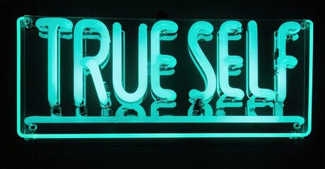 Bright neon sign displays words true self against dark background. Minimalist design evokes introspection, identity exploration. Turquoise glow dominates image.