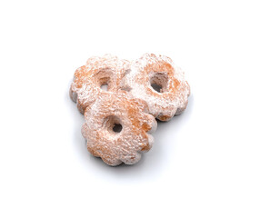 Flower-shaped cookies dusted with powdered sugar on white background.