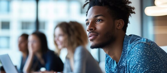 Focused young man in a group setting