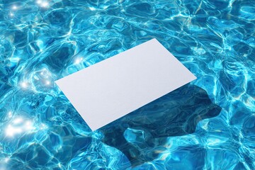 White rectangular card floats peacefully on the surface of shimmering blue water