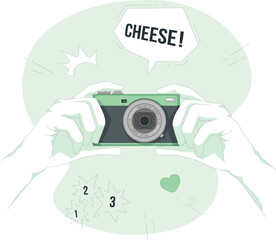 Hands holding a camera with a speech bubble saying cheese