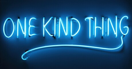 Bright blue neon sign displays text one kind thing. Dark background emphasizes glowing script, simple design. Modern aesthetic.