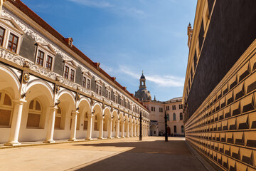 Historic Stallhof courtyard in Dresden, Germany, with arcaded Renaissance architecture and the womens church dome in the background. Iconic old town landmark reflecting Saxon history and culture