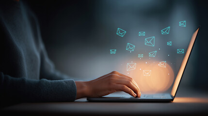 Person hands typing on laptop with flying email icons, digital communication concept, email marketing, newsletter, sending messages, remote work at night with bokeh background.