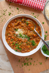 Red lentil stew with minced meat, tomatoes, carrots, celery, onions an garlic. Topped with parmesan cheese
