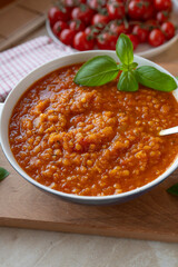 Vegan Red lentil / Tomato soup with pumpkin on a plate fresh and homemade cooked