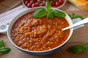 Vegan Red lentil / Tomato soup with pumpkin on a plate fresh and homemade cooked