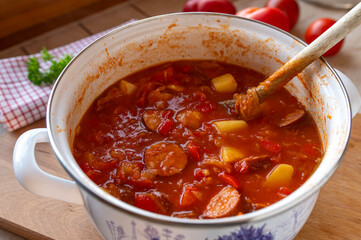 Sauerkraut Soup with sausage fresh and homemade cooked in a pot