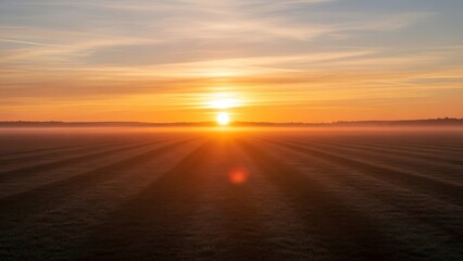 Sunset over vast agricultural landscape fields.
