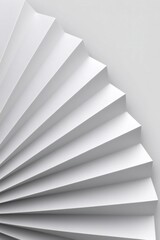 White pleated paper fan creating an abstract textured background with geometric patterns and copy space