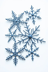 A decorative Christmas vector set featuring blue crystal snowflakes and frost patterns in star shapes on a white background for winter holiday ornament design