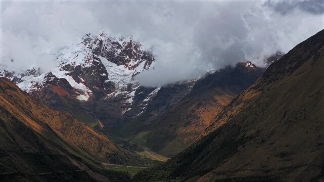 Mount Humantay Salkantay Peru aerial drone high altitude Peruvian Andes snow capped glacier peaks Laguna Humantay Lake landscape dry season cloudy sunny morning Anta province pan left motion