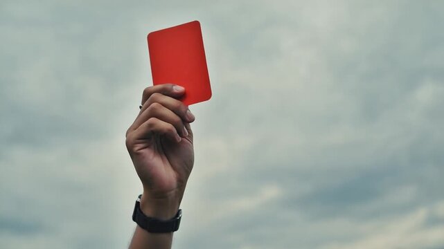 Soccer referee with the red card.
