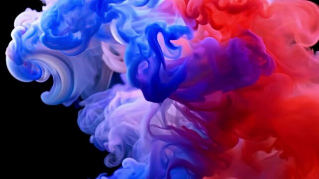 Colorful liquid mixing in water creates interesting patterns and shapes in a dark background