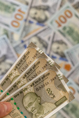 Obraz premium India money. Currency exchange rate. Indian rupees vs US dollar. Economic and financial concept. Banknotes of 500 rupees against USD. business background. Close up. Vertical