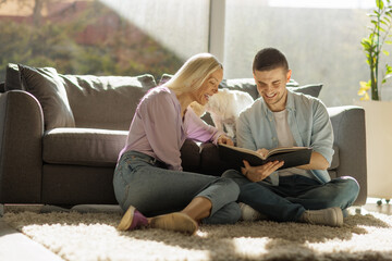 Happy couple reading a book together