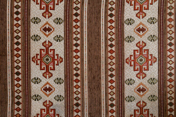 Traditional Anatolian kilim textile pattern with geometric motifs and earthy tones, showcasing handcrafted cultural fabric design