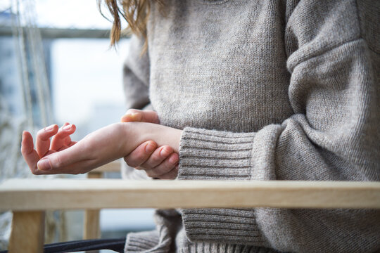 Close-up of woman suffering from hand pain.	