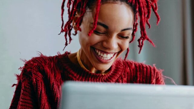 Smiling Woman with Red Dreadlocks Using Laptop