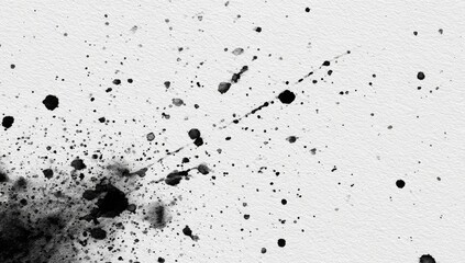 Black ink splatters abstract design on textured white paper surface