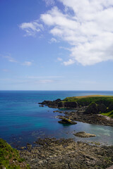 Fototapeta premium Views over fields and coast line rocks in Scotland 