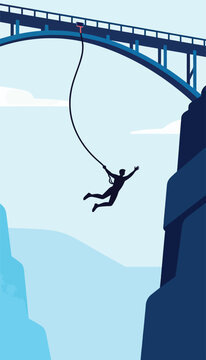 Silhouette of person bungee jumping from bridge over rocky gorge