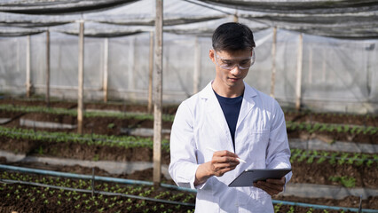 Researchers using tablet in greenhouse, agriculture technology
