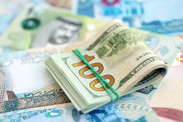 Bahraini dinar currency money bills and bunch of us dollar banknotes close up. The concept of economics and currency exchange